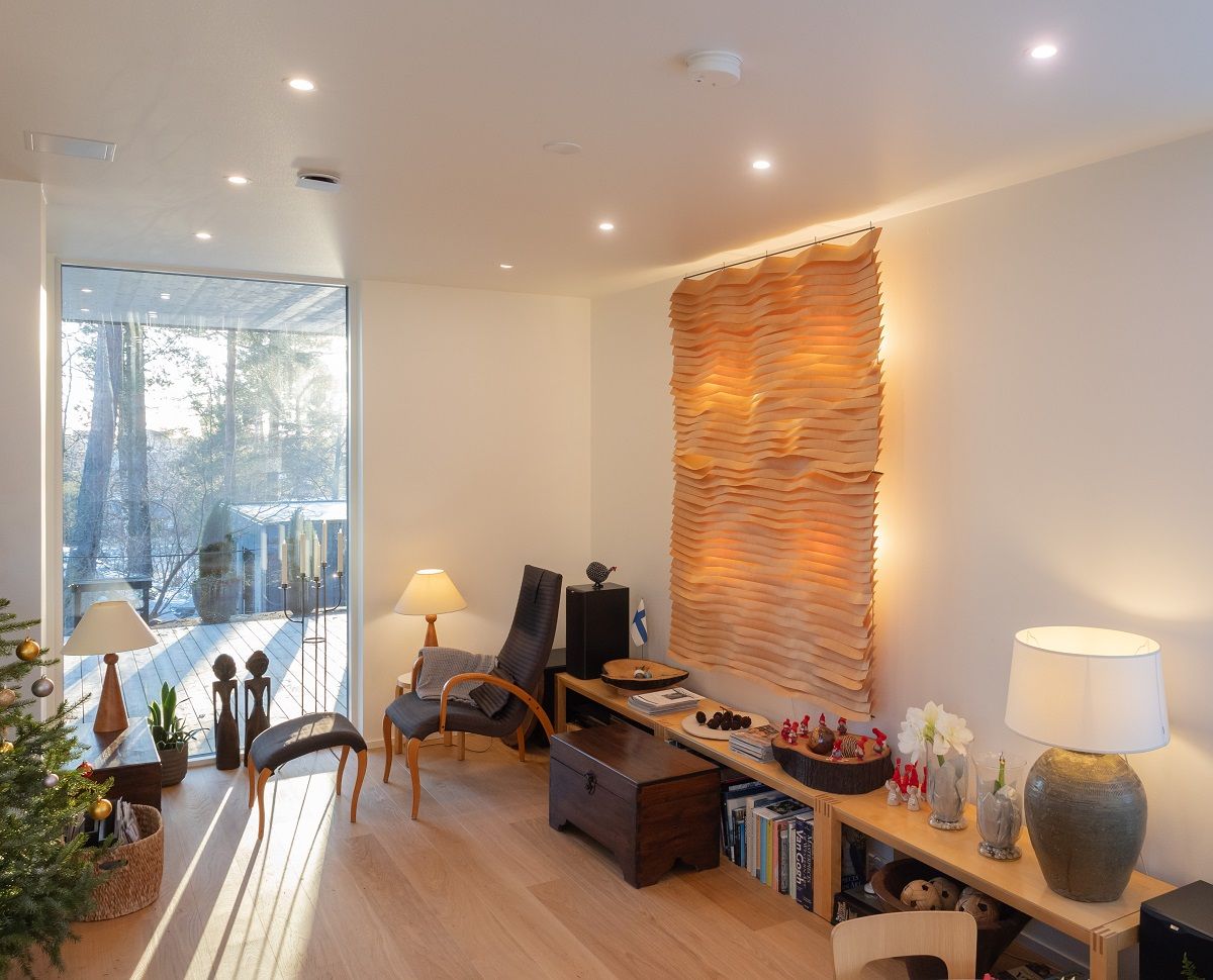 Il soggiorno è illuminato simmetricamente da plafoniere a incasso e completato da lampade da tavolo decorative.